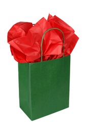 Green gift bag with red tissue isolated on white background