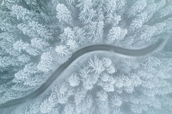 Icy Road in Winter Forest. Winter Weather. Drone View.