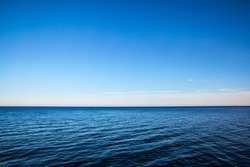 Seascape with sea horizon and almost clear deep blue sky - Background