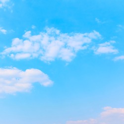 Pale blue sky with white clouds - background with space for your own text