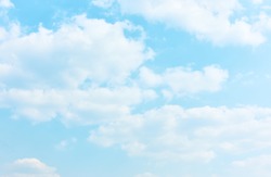 Pale blue sky with white clouds - textured background