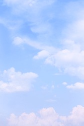 Bright blue sky with light clouds - vertical background, cloudscape