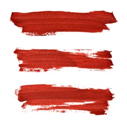 Brush strokes of red acrylic paint isolated on the white background 