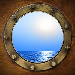 Boat porthole with ocean view close up