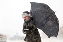 Girl with umbrella during snow storm