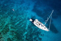 amazing view to yacht, swimming woman and clear water caribbean paradise