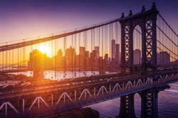New York City - beautiful sunset over manhattan with manhattan and brooklyn bridge 