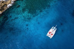 Amazing view to Catamaran cruising in open sea at windy day. Drone view - birds eye angle Coco Island.