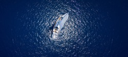 Amazing view to Yacht sailing in open sea at windy day. Drone view - birds eye angle.