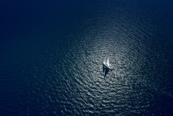 Amazing view to Yacht sailing in open sea at windy day. Drone view - birds eye angle. Yachting theme.