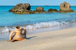 Old greek Amphora on a seashore. Elafonissi beach, Crete, Greece. Selective focus
