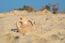 View to greek amphora on a sandy beach. Greece