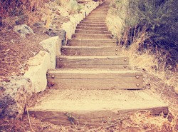  wooden steps going up a hill toned with a retro vintage instagram filter effect app or action 