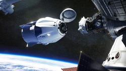 SpaceX Crew Dragon spacecraft docking to the International Space Station. Dragon is capable of carrying up to 7 passengers to and from Earth orbit, and beyond. Elements of this image furnished by NASA