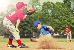 Boy sliding into base during a baseball game with Instagram style filter