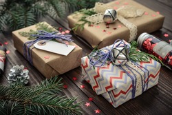 Christmas gifts with christmas decoration on wooden background closeup
