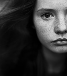 black and white portrait of a beautiful girl with freckles