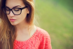 portrait of a beautiful hipster girl in glasses close up