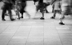 city people walking on piazza in motion blur