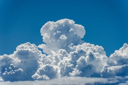 Cumulonimbus, closeup of puffy white clouds in the blue sky, full frame