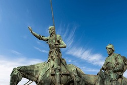Closeup of the bronze statues of Don Quixote de la Mancha and Sancho Panza, part of the monument to Miguel de Cervantes, 1929, in Plaza de Espana (Spain square), Madrid downtown, Spain, Europe. 