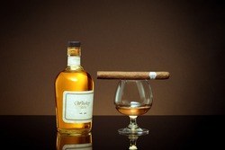 NO LOGOS OR TRADEMARKS!  SELF MADE LABELS! close up view of cigar, bottle of whiskey and glass on color back. 