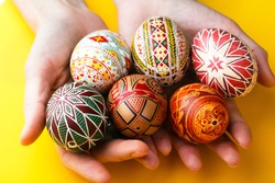 happy easter card. girl holds in hands beautiful Easter egg Pysanka handmade - ukrainian traditional 
