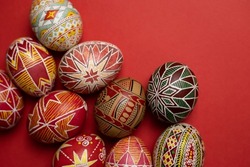 happy easter card. beautiful Easter egg Pysanka handmade on a red background