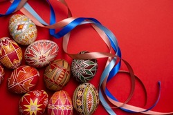 happy easter card. beautiful Easter egg Pysanka handmade on a red background
