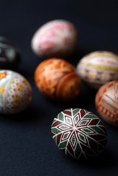 happy easter card. beautiful Easter egg Pysanka handmade on a black background