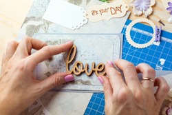 scrapbook background. Hands, Card and tools with decoration. Love