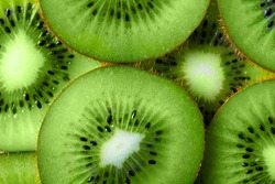 background made with a heap of sliced kiwi