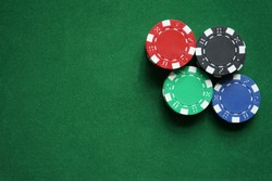 Stacks of gambling/poker chips on green background, casino concept