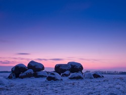 Dolmen with snow in winter landscape