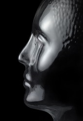 translucent reflective human head made of glass in black back