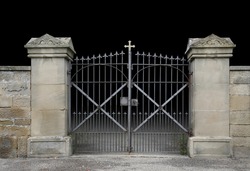 entrance of a graveyard with a closed wrought-iron gate in dark gradient back
