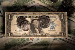 Half Dollar and Dollar coins on antique US Dollar Silver Certificate banknote. USA currency