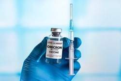Injectable vaccine for the vaccination program of coronavirus Omicron. Doctor holds the hand Vaccine vial and syringe to administer vaccination doses for New Variant of the Covid-19 Omicron B.1.1.529