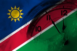 Namibia, Namibian flag with clock close to midnight in the background. Happy New Year concept