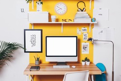 Office workplace with computer./ Modern creative workspace on yellow wall. 