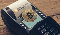 Customer pays by bitcoin to pay a bill at the cafe (bitcoin accepted here)