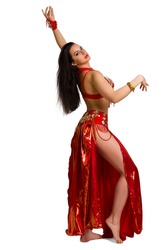 Beautiful young girl in a red suit oriental dance in motion isolated on white background