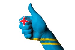 Hand with thumb up gesture in colored aruba national flag as symbol of excellence, achievement, good, - for tourism and touristic advertising, positive political, social management of country