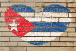 heart shaped flag in colors of Cuba on brick wall