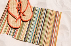 straw sandals on straw beach mat