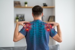 Shoulder-scapular periarthritis, shoulder blades pain, joint inflammation, man with backache at home, human skeleton, painful area highlighted in red