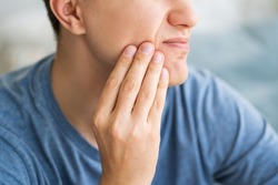 A man with toothache, periodontal disease in wisdom teeth, health problems concept