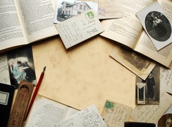 Vintage background with old books, postcards and photographs