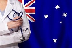 Australian medicine and healthcare concept. Doctor close up against flag of Australia background