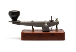 Telegraph key or Morse key isolated on white background. Vintage Morse code telegraphy device side view.